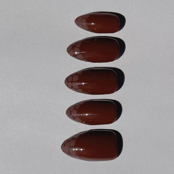 Glossy Brown Press-On Nails with snake skin French tips.